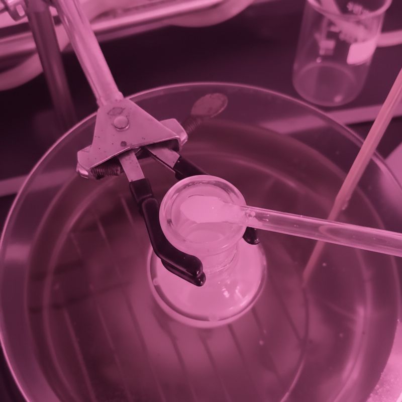 Laboratory glassware with clamp and pipette during the testing of Biomera’s V3 plastic-free natural polymer in development.